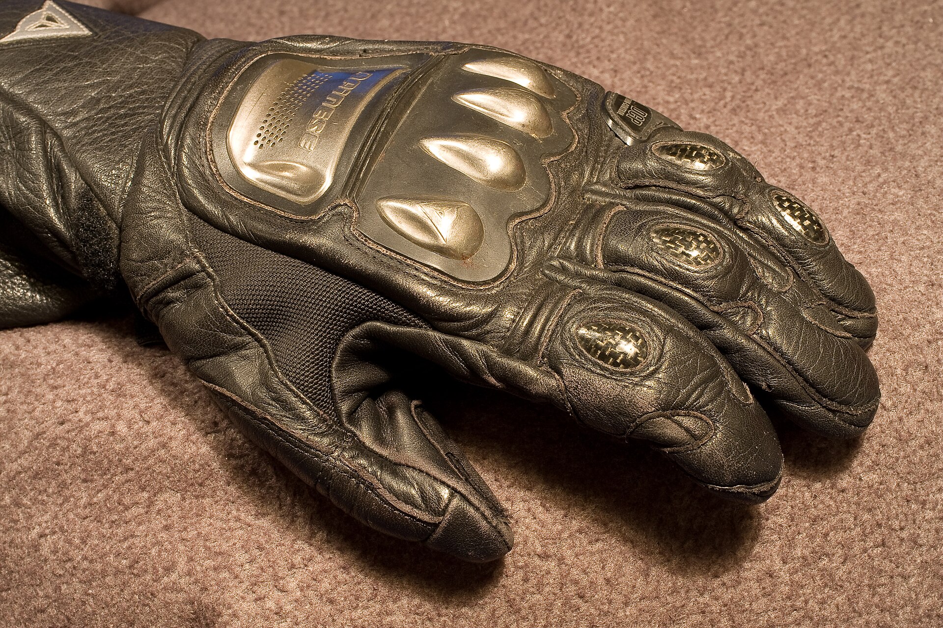 Motorcycling racing glove. Notice the carbon fibre protectors for ligaments in fingers as well as the titanium knuckle protectors and shock absorbing construction of backhand.